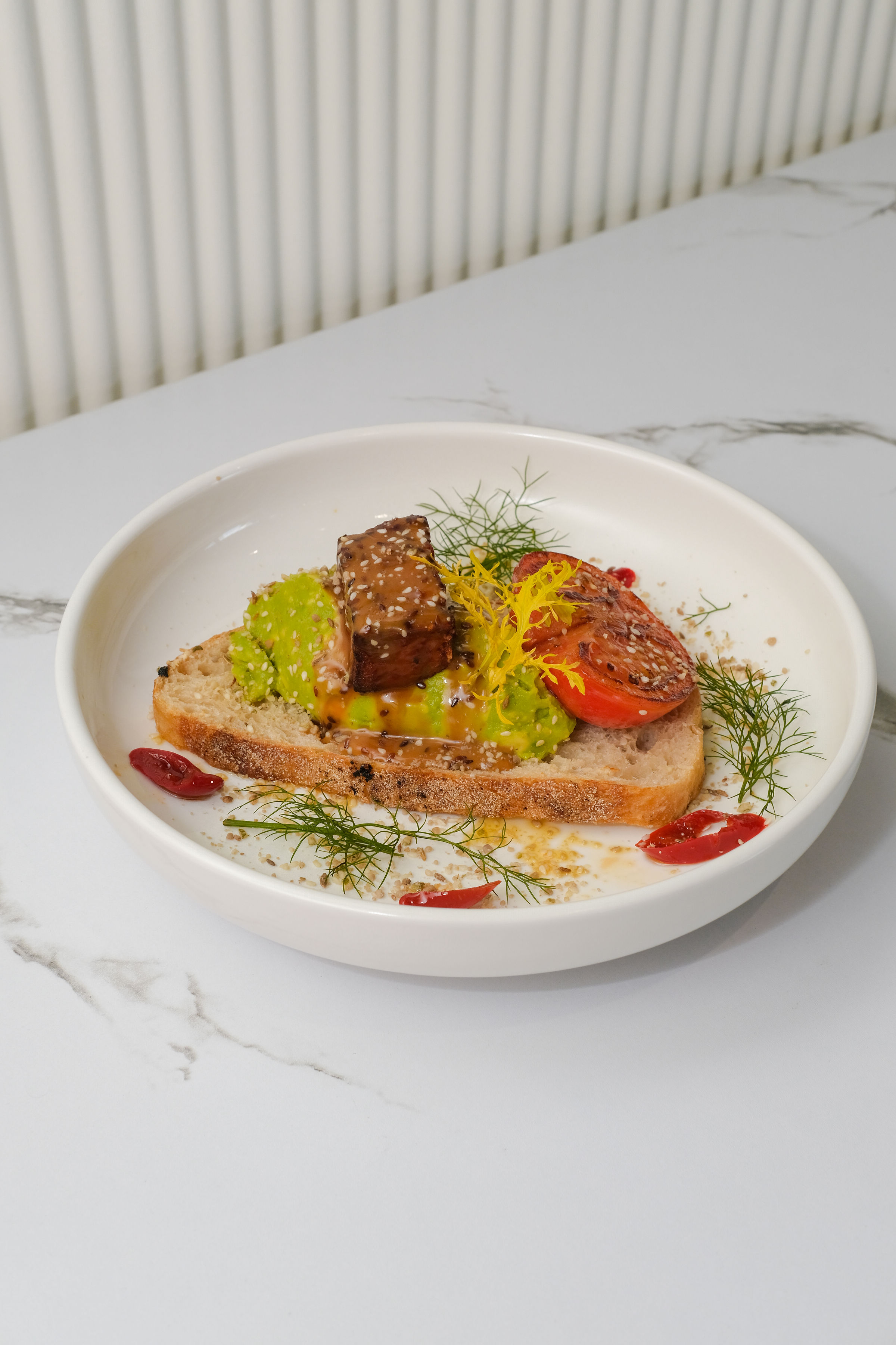Avocado toast with poached eggs and dukkah